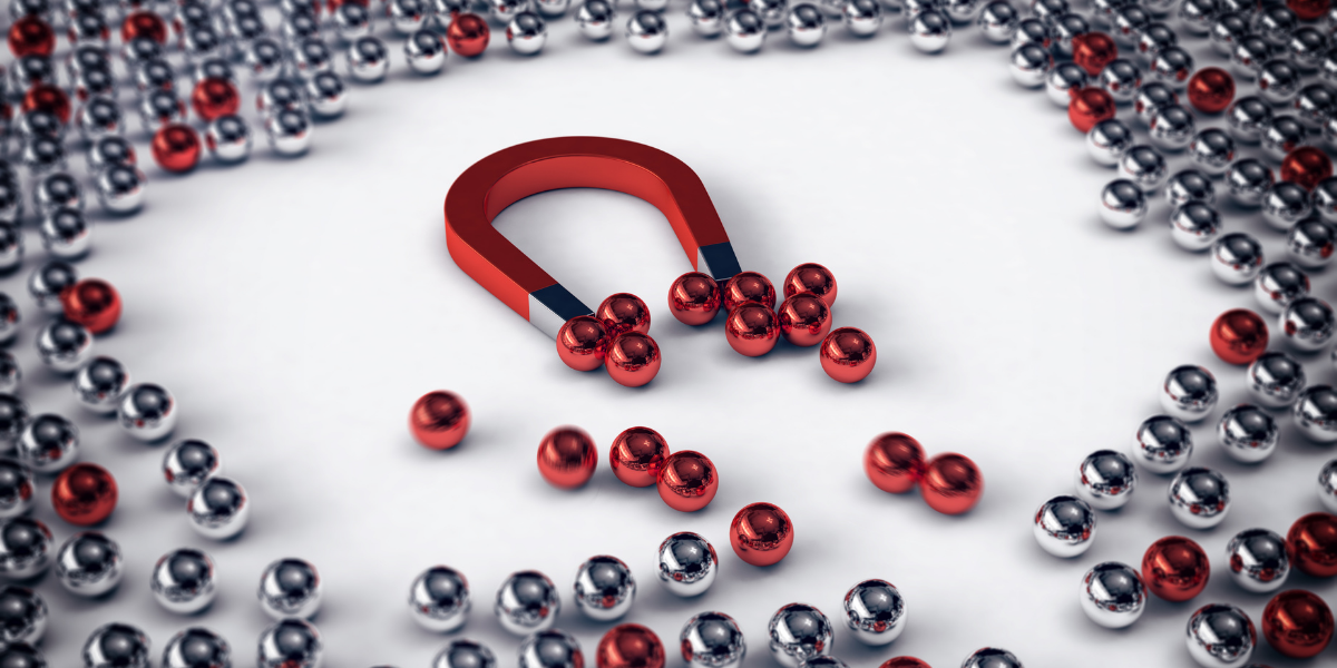 magnet attracting red and silver balls representing recruitment strategy to attract both the active and passive candidate