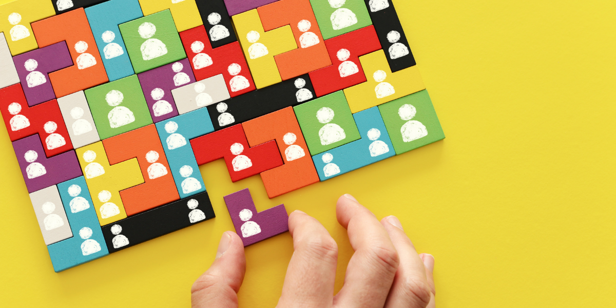 Hand putting final puzzle piece in place, representation of recruitment firms
